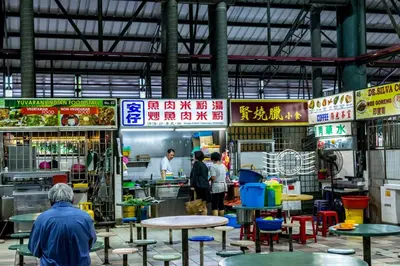 a group of people walking around a market with tables at Super 8 Hotel @ Bayan Baru in Bayan Lepas