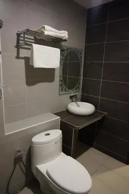 a bathroom with a white toilet and a sink at Super 8 Hotel @ Bayan Baru in Bayan Lepas