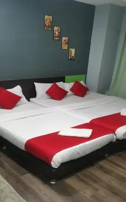 a large bed with red and white pillows on it at Lucky Hotel in Sungai Petani