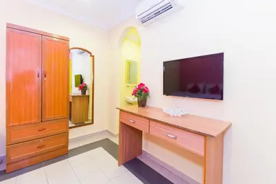 a bathroom with a television on a wall at Hotel O Comfort in Ipoh