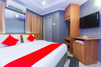 a bedroom with a bed and a flat screen tv at Hotel O Comfort in Ipoh