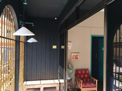 a hallway with a red chair and a blue wall at Wogoxette Upstairs, A Private Kampung Stay In Cameron Highlands in Cameron Highlands