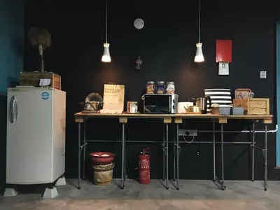 a table with a refrigerator in a room at Wogoxette Upstairs, A Private Kampung Stay In Cameron Highlands in Cameron Highlands
