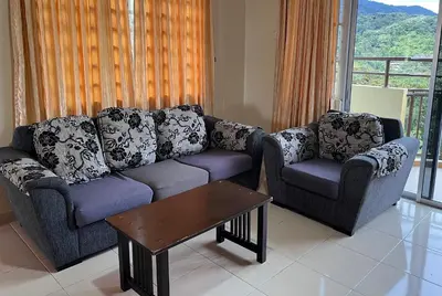 a living room with a couch and two chairs at Cameron Supersave Apartment @ Crown Imperial Court in Brinchang