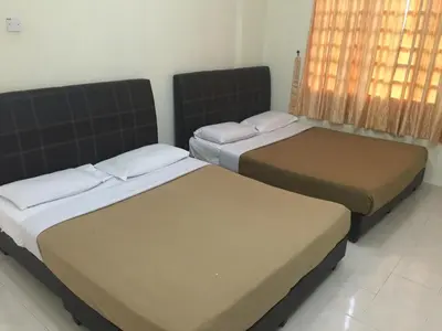 two beds sitting in a room with a window at Cameron Supersave Apartment @ Crown Imperial Court in Brinchang