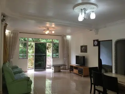 a living room with a couch and a table and a television at Cameron Supersave Apartment @ Crown Imperial Court in Brinchang