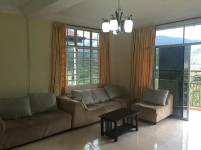 a living room with a couch and a table at Cameron Supersave Apartment @ Crown Imperial Court in Brinchang