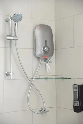 a shower in a bathroom with a hair dryer at Mii Smile Hotel Penang in George Town