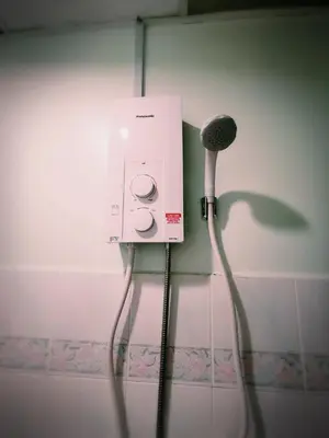 a hair dryer and a blow dryer in a bathroom at Sea & Wave #2 Coral Bay Apartment in Pangkor