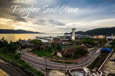 a view of a town next to a body of water at Sea & Wave #2 Coral Bay Apartment in Pangkor