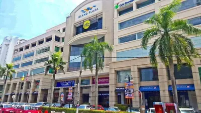 a large building with palm trees in front of it at Selamat Datang @ 118 Island Plaza Superior Suite in Tanjong Tokong