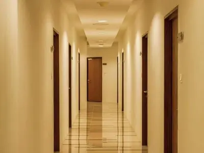 a hallway of a building with doors and a tile floor at Selamat Datang @ 118 Island Plaza Superior Suite in Tanjong Tokong