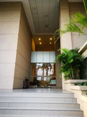 a lobby of a building with stairs and plants at Selamat Datang @ 118 Island Plaza Superior Suite in Tanjong Tokong