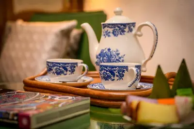 a table with two blue and white cups and a tea pot at Museum Hotel in George Town