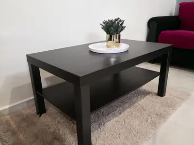 a black coffee table with a plate on top at Hutan Melintang Homestay 12Pax Walk to 7Eleven KFC by willson in Hutan Melintang
