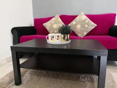 a black coffee table in front of a couch at Hutan Melintang Homestay 12Pax Walk to 7Eleven KFC by willson in Hutan Melintang