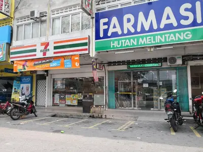 a group of motorcycles parked in front of a store at Hutan Melintang Homestay 12Pax Walk to 7Eleven KFC by willson in Hutan Melintang