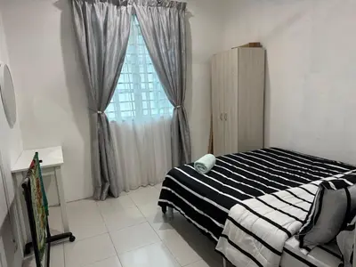a bedroom with a bed and a window at Homestay Samsul Sungkai in Sungkai