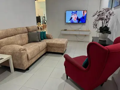 a living room with a couch and a tv at Homestay Samsul Sungkai in Sungkai
