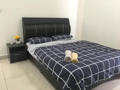 a bedroom with a bed with two towels on it at Woodsbury Suites 7722 Butterworth Penang in Butterworth