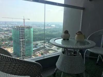 two birds sitting on a table in front of a window at Woodsbury Suites 7722 Butterworth Penang in Butterworth