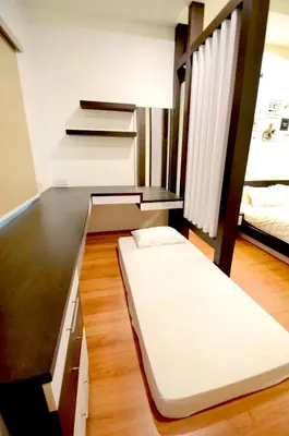 a small bedroom with a bed and a wooden floor at Decozy 3.0 Semi-D in Ipoh