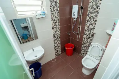 a small bathroom with a toilet and a sink at GLYSM Tambun Stay 