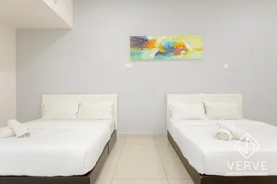 two beds in a room with a painting on the wall at Ipoh Luxury Suites by Verve (18 Pax) EECH16 in Ipoh