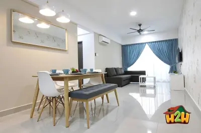 a dining room and living room with a table and chairs at H2H - Eleven14 Majestic Ipoh in Ipoh