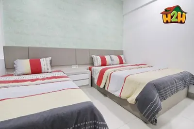 a bedroom with two beds in a room at H2H - Eleven14 Majestic Ipoh in Ipoh