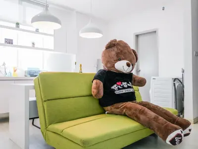 a teddy bear sitting on a green chair at Penang Straits Garden Condominium Georgetown in George Town