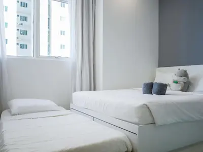 two white beds in a room with a window at Penang Straits Garden Condominium Georgetown in George Town