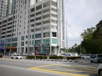 a large white building with cars parked in front of it at Penang Straits Garden Condominium Georgetown in George Town