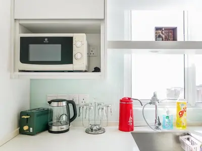 a kitchen counter with a microwave oven and a kitchen counter sidx sidx at Penang Straits Garden Condominium Georgetown in George Town
