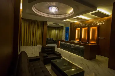 a lobby with a waiting room with a chair and a mirror at Hotel Pen Mutiara in Kampong Batu Maung