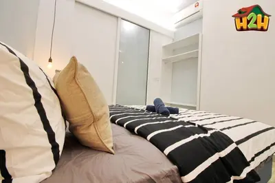 a bed with pillows on it in a room at H2H - Sweet Cottage - Octagon in Ipoh
