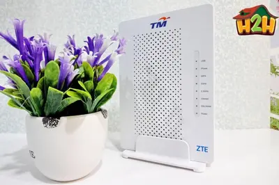 a vase of purple flowers next to a thermometer at H2H - Sweet Cottage - Octagon in Ipoh