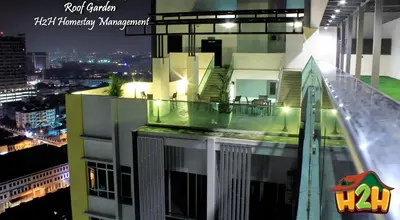 a view of a building with a balcony at night at H2H - TT Court Majestic Ipoh in Ipoh