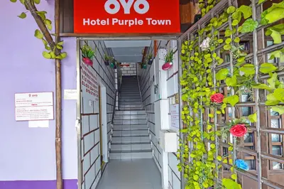 a sign for a hotel purple room with plants at Hotel O Purple Town in Sekincan