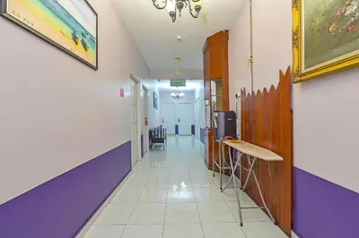 a hallway of a hospital with purple and purple walls at Hotel O Purple Town in Sekincan