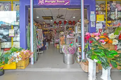 a flower shop with flowers in the aisle at Hotel O Purple Town in Sekincan
