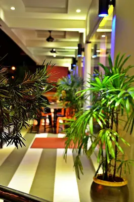 a room with some plants on the floor of a building at Hotel Eastana Ipoh in Ipoh