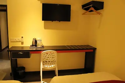 a room with a desk with a television and a chair at Hotel Eastana Ipoh in Ipoh