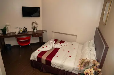 a hotel room with a bed and a desk and a desk at Hotel Eastana Ipoh in Ipoh