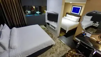 a hotel room with a bed and a television at Bedrock Hotel Ipoh in Ipoh