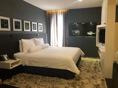a bedroom with a large bed and a television at Bedrock Hotel Ipoh in Ipoh