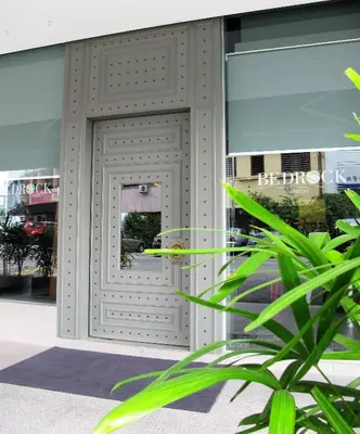 a door on a building with a plant in front of it at Bedrock Hotel Ipoh in Ipoh