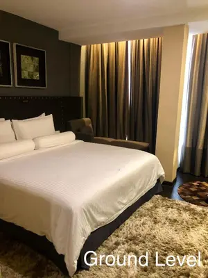 a bedroom with a large white bed and a window at Bedrock Hotel Ipoh in Ipoh