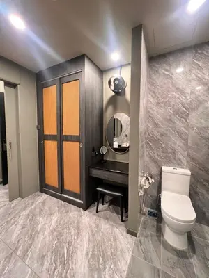 a bathroom with a toilet and a sink and a mirror at Bedrock Hotel Ipoh in Ipoh