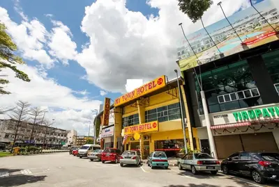 a street with cars parked in front of a building at My Town Hotel in Ipoh